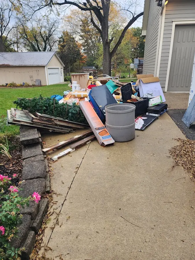 Dumpster being loaded with debris for Estate Cleanout Dumpster Rental in West Bradford